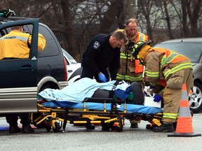 Paramedics transport one of two patients to hospital following a car accident on Tecumseh Road East and Clover Avenue on Jan. 29, 2013. (JASON KRYK/The Windsor Star)