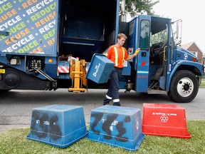 City of Windsor recycle truck operator Chet Salisbury picks up a heavy load on Cameron Avenue, Tuesday July 13, 2010. (Windsor Star files)