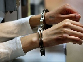 File photo of a person in prison in handcuffs. (Postmedia News files)