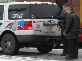 Windsor police detectives and an officer with the forensics identification unit conduct an investigation at the rear of The Lumberjack Restaurant, Monday, January 28, 2012.  A female employee of the restaurant was assaulted and an unspecified amount of money was stolen.  (DAX MELMER/The Windsor Star)
