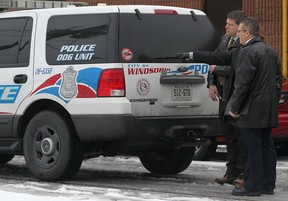 Windsor police detectives and an officer with the forensics identification unit conduct an investigation at the rear of The Lumberjack Restaurant, Monday, January 28, 2012.  A female employee of the restaurant was assaulted and an unspecified amount of money was stolen.  (DAX MELMER/The Windsor Star)