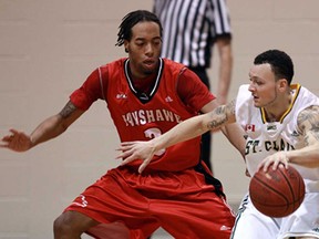 St. Clair's Lamar Milburn, right, is guarded by Fanshawe's Chavaun Miller-Bennett Wednesday at St. Clair College. (TYLER BROWNBRIDGE/The Windsor Star)