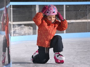 Tabitha Main, 5, and her dad Sean Main enjoyed a sunny morning skate Monday, Jan. 7, 2013, at the Charles Clark Square in downtown Windsor, Ont. It was Tabitha's second time on skates. Here she adjusts her helmet after she took a spill. (DAN JANISSE/The Windsor Star)