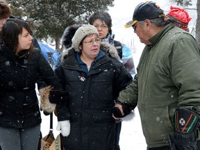 Attawapiskat Chief Theresa Spence is helped back to her teepee after greeting and welcoming supporters as they visit her on Victoria Island in Ottawa on Monday, January 3, 2013. Spence is in her fourth week of a hunger strike calling on Harper to meet and discuss First Nations issues. THE CANADIAN PRESS/Sean Kilpatrick