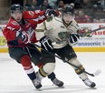 Windsor's Alex Khokhlachev (L) and London's Max Domi battle for position in this 2012 file photo.    (DAN JANISSE/The Windsor Star)