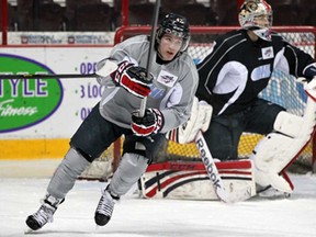 Newly acquired centre Alex Aleardi, left, skates in front of goaltender Jordan DeKort during Windsor Spitfires practice at WFCU Centre Tuesdayl. (NICK BRANCACCIO/The Windsor Star)