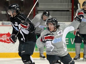 Alex Aleardi, centre, breaks free from Patrick Sieloff, left, at Windsor Spitfires practice at WFCU Centre Tuesday. NICK BRANCACCIO/The Windsor Star)