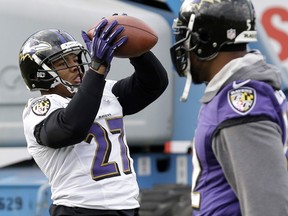 Baltimore Ravens running back Ray Rice, left, catches a pass as linebacker Ray Lewis walks past during an NFL Super Bowl XLVII football practice on Wednesday, Jan. 30, 2013, in New Orleans. The Ravens face the San Francisco 49ers in Super Bowl XLVII on Sunday, Feb. 3. (AP Photo/Patrick Semansky)