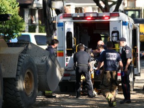 In this file photo, emergency services personnel tend to a patient following an industrial accident involving a construction worker and a front-end loader on the 1200 block of McKay Avenue on Wednesday, June 1, 2011. (DYLAN KRISTY/The Windsor Star)