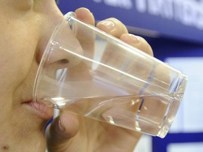 A woman drinking water. (Postmedia News files)