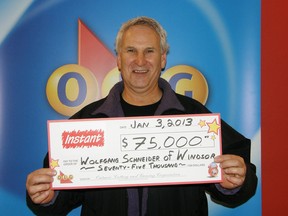 Windsor resident Wolfgang Schneider collects his $75,000 cheque from the OLG prize centre on Jan. 3, 2013. (Handout / The Windsor Star)