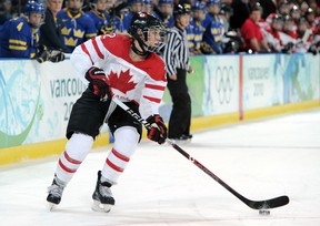 File photo: Meghan Agosta of Canada controls the puck during the ice hockey women's preliminary game between Canada and Sweden on day 6 of the 2010 Winter Olympics at UBC Thunderbird Arena on February 17, 2010 in Vancouver, Canada.  (Photo by Harry How/Getty Images)