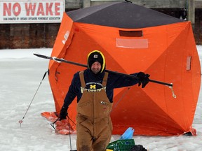 Jeff Galasso packs up his fishing tent during Friday's winter stormas area residents and motorists battle the elements during a winter storm Friday February 8, 2013.  The storm did not bother the fishing though, with several anglers reporting 'jumbo' perch. (NICK BRANCACCIO/The Windsor Star)