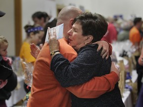 Paul Hicks, Aidan Hicks' father, hugs his aunt Terry Zakoor during Thursday's fundraiser event at Average Joe's in Windsor.  (DAN JANISSE/The Windsor Star)