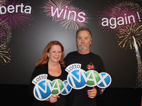 Darrell and Laurie Szczerba of Calgary won the $30-million prize for the February 15 Lotto Max draw. They picked up their cheque Friday, Feb. 22. (THE CANADIAN PRESS)
