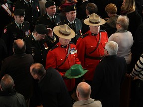 Members of the Royal Canadian Mounted Police carry out the green Stetson that belonged to the late Honourable Eugene Whelan while at his funeral at St. John the Baptist Church in Amherstburg, Ont., Saturday, February 23, 2013.  (DAX MELMER/The Windsor Star)