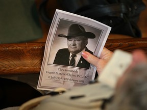 A woman holds the program for the funeral of the late Hon. Eugene Whelan at St. John the Baptist Church in Amherstburg on Saturday, Feb. 23, 2013.  (DAX MELMER/The Windsor Star)