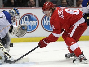 Detroit's Justin Abdelkader records a shot on St. Louis goaltender, Brian Elliott, left, as the Detroit Red Wings host the St. Louis Blues at Joe Louis Arena on Friday, Feb. 1, 2013.  Detroit won 5-3.  (DAX MELMER/The Windsor Star)