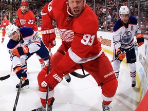 Detroit's Johan Franzen, centre, is surrounded by Oilers during Saturday's game at Joe Louis Arena. (Getty Images)