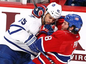 Toronto's Mark Fraser, left, is checked by Montreal's Brandon Prust Saturday at the Bell Centre. (John Kenney/THE GAZETTE)