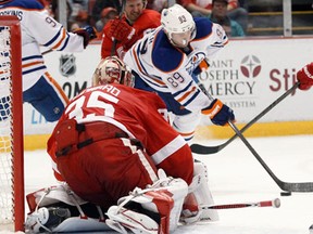 Edmonton's Sam Gagner, right, takes a shot against Detroit goalie Jimmy Howard Saturday in Detroit. (AP Photo/Duane Burleson)