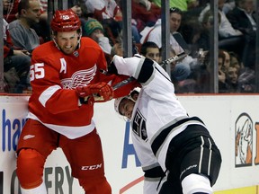 Detroit's Niklas Kronwall, left, is checked by Simon Gagne of the Kings at Joe Louis Arena in Detroit. (AP Photo/Carlos Osorio)