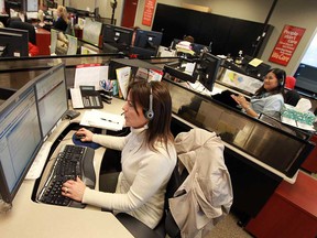 Denise Meloche answers a call during an open house at the 211/311 call centre at 400 City Hall Square in Windsor on Monday, February 11, 2013. The city celebrated the fifth anniversary of the 211 service.           (TYLER BROWNBRIDGE / The Windsor Star)