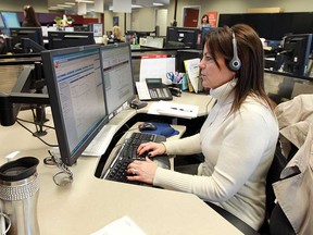 Denise Meloche answers a call during an open house at the 211/311 call centre at 400 City Hall Square in Windsor in February 2013. Letter writer Jerry Gervais is grateful for the service.  (Windsor Star files)