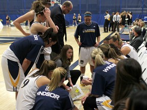 The University of Windsor Lancers girls basketball team huddle before the start of the second half against the Waterloo Warriors at the St. Denis Centre. (DAX MELMER/The Windsor Star)