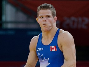 L'Essor grad David Tremblay reacts after loosing his match in men's freestyle 55kg wrestling at the London 2012 Olympic Games in London, England. (Tyler Anderson/Postmedia Olympic Team)