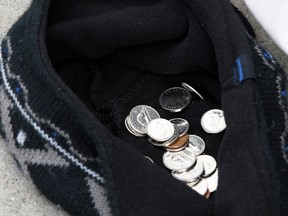 In this file photo, panhandler Matt, uses a soft approach, not really asking for money.  Matt keeps an open hat at his feet, hoping to catch a few coins from passersby on Ouellette Avenue February 15, 2013.  (NICK BRANCACCIO/The Windsor Star file photo).