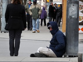 Panhandler Matt, uses a soft approach, not really asking for money.  Matt keeps an open hat at his feet, hoping to catch a few coins from passersby on Ouellette Avenue February 15, 2013.  (NICK BRANCACCIO/The Windsor Star).