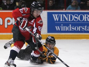 Windsor's Alexander Khokhlachev, left, is checked by Sarnia's Charles Sarault at the WFCU Centre. (DAX MELMER/The Windsor Star)