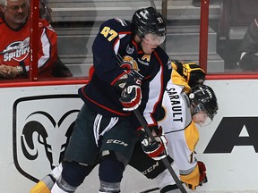 Windsor's Brady Vail, left, checks Sarnia's Charles Sarault Friday at the WFCU Centre. (TYLER BROWNBRIDGE/The Windsor Star)