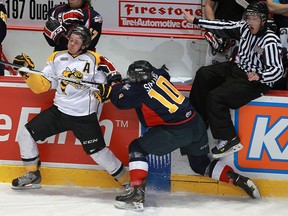 Windsor's Patrick Sieloff, right, checks Sarnia's Nickolas Latta at the WFCU Centre. (TYLER BROWNBRIDGE/The Windsor Star)