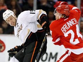 Anaheim's Ryan Getzlaf, left, is checked by Detroit's Damien Brunner Friday. (AP Photo/Duane Burleson)