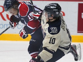 Windsor's Patrick Sieloff, right, is checked by Saginaw's Eric Locke at the WFCU Centre. (NICK BRANCACCIO/The Windsor Star)