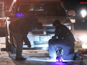 Police and firefighters look over the scene of an accident involving a pedestrian in the 1000 block of Coventry Court in Windsor on Tuesday, February 5, 2013. A man was transported to hospital with serious injuries.          (TYLER BROWNBRIDGE / The Windsor Star)