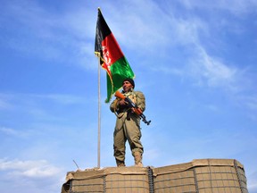An Afghan Local Police (ALP) personnel keeps watch in Nor Gal district Kunar province on February 13, 2013. The Afghan government welcomed President Barack Obama's announcement that the United States will withdraw 34,000 troops from the war-torn country over the next year. NATO, which has about 37,000 troops in Afghanistan, will also withdraw them in stages before the end of 2014. AFP PHOTO/ Noorullah Shirzada