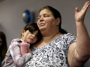 Cynthia Murray of Dothan holds her granddaughter Ashleigh Murray as she and others pray during a celebration for Ethan, the boy who was held hostage for a week in an underground bunker, Wednesday, Feb. 6, 2013 at the Midway Assembly of God in Midland City, Ala. Ethan, who was rescued Monday, turned six on Wednesday. His captor, Jimmy Lee Dykes, was killed during the rescue operation. (AP Photo/Dave Martin)