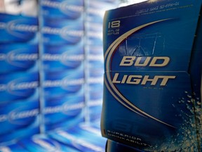 n this Monday, Jan. 28, 2013, file photo, Bud Light beer is shown in the aisles of Elite Beverages in Indianapolis. Beer lovers across the country have filed $5 million class-action lawsuits accusing Anheuser-Busch of watering down its Budweiser, Michelob and other brands. (AP Photo/Michael Conroy, File)