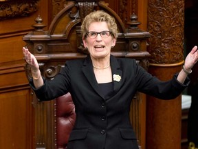 Ontario Premier Kathleen Wynne salutes the gallery after her swearing-in ceremony at Queen's Park in Toronto on Monday, Feb. 11, 2013. (THE CANADIAN PRESS/Frank Gunn)
