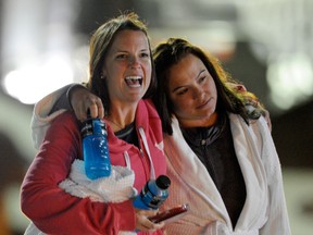 Kristina Courson, left, of Paris, Texas, is embraced by Jamie Hilliard, of Denison, Texas, after getting off the cruise ship Carnival Triumph in Mobile, Ala., Thursday, Feb. 14, 2013. The ship with more than 4,200 passengers and crew members has been idled for nearly a week in the Gulf of Mexico following an engine room fire. (AP Photo/G M Andrews)