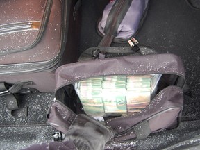 An open bag containing $61,140 in cash is shown in the trunk of a crashed vehicle, near Darfield, B.C., photo released by police on Friday Feb. 1, 2013. A driver who seemed to be in a big hurry lost more than a few dollars with a speeding ticket, when police found the cash after searching the driver's car, on drug suspicions. THE CANADIAN PRESS/HO, RCMP