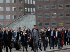 This Oct. 25, 2012 file photo shows workers walking across London Bridge to their work places in the City of London. For visitors on a literary tour of London, Charles Dickens' "Great Expectations" included a scene in which Pip crossed the bridge in great despair after learning that Estella was to be married to Drummle. (AP Photo/Sang Tan, file)