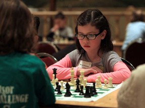 Rose Forshaw from Saint-Ambroise school, right,  thinks about the next chess move during the 2013 Windsor Chess Challenge at the Ciociaro Club in Tecumseh, Ontario on February 26, 2013.  More than 1,000 students will take part in the two-day event. (JASON KRYK/The Windsor Star)