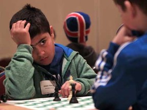 Adam Salloum from Monseigneur-Jean-Noel, left, looks up at his chess opponent  Alex Brule from Pavillon des Jeunes during the 2013 Windsor Chess Challenge at the Ciociaro Club in Tecumseh, Ontario on February 26, 2013.  More than 1000 students will take part in the two-day event. (JASON KRYK/The Windsor Star)