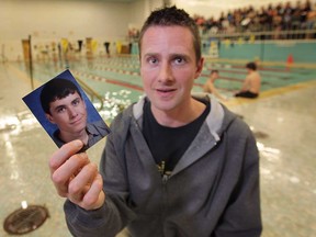 A fundraising event was held Thursday, Feb. 7, 2013, for Cole Kierdorf at the Riverside High School in Windsor, Ont. The 20-year-old Kierdorf, a Riverside grad and standout swimmer was injured recently snowboarding in Michigan. Riverside swim coach John Loncke who organized the event holds a photo of Kierdorf during the event.   (DAN JANISSE/The Windsor Star)