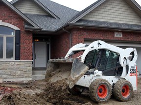 Mike Dinchik from Timberland Homes, uses a Bobcat to prepare the front yard of a newly built home on Ellis Street in LaSalle, Monday, February 11, 2013.  (DAX MELMER/The Windsor Star)