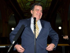 In this file photo, Ontario Finance Minister Dwight Duncan smiles as he starts his final news conference to announce his resignation at the Ontario Legislature in Toronto on Wednesday February 7, 2013. (THE CANADIAN PRESS/ Frank Gunn)